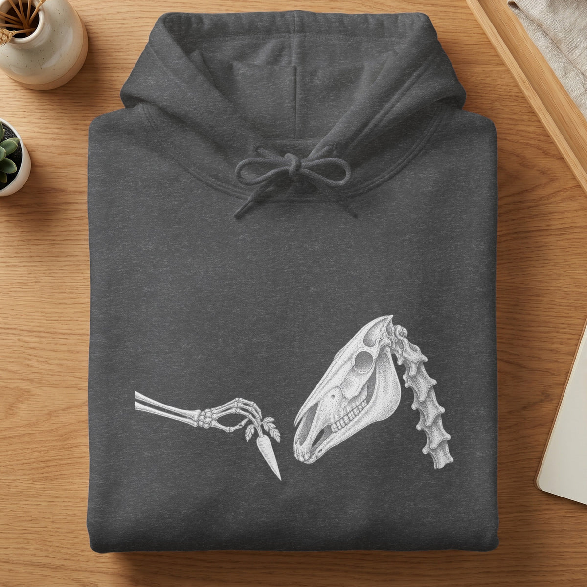 Dark grey hoodie with a skeletal horse head graphic and a skeleton hand offering a carrot.