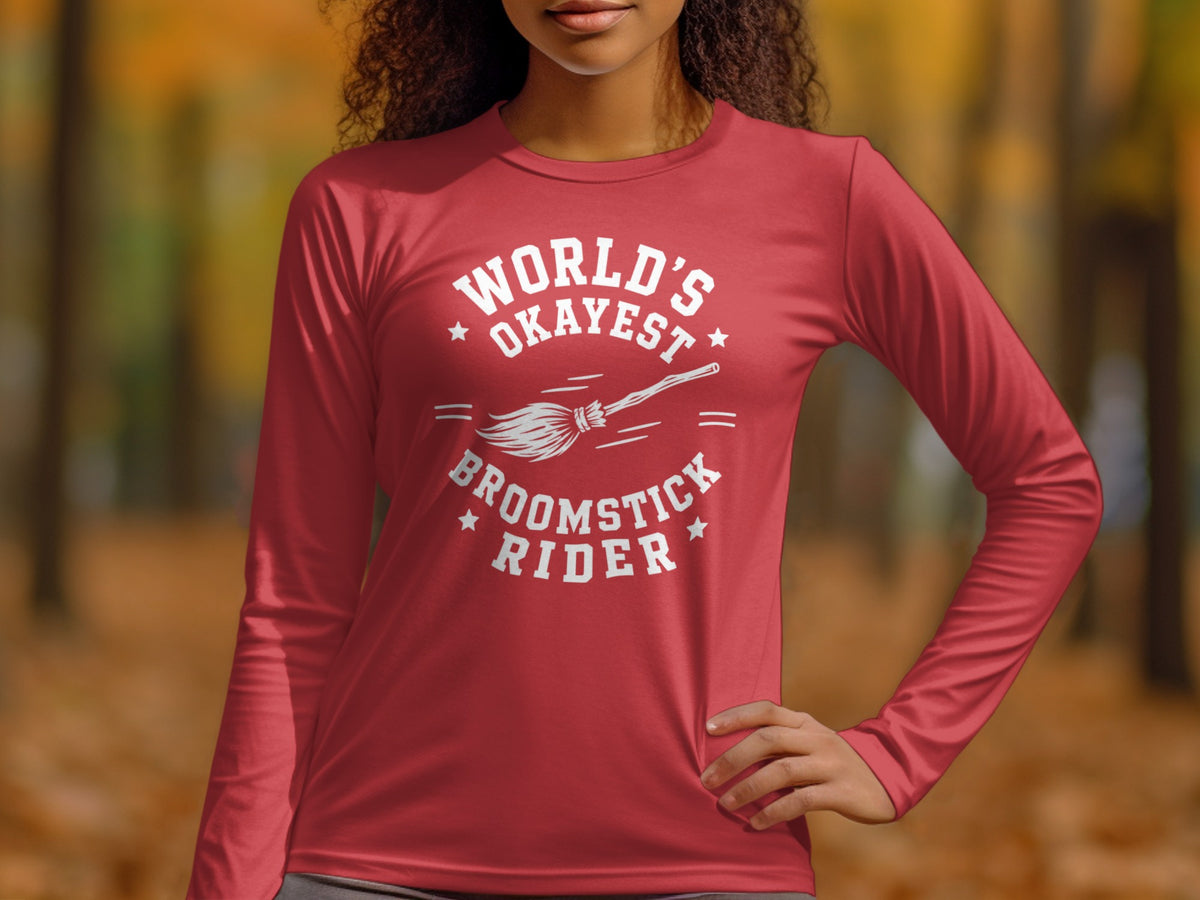Red long-sleeve shirt with "World's Okayest Broomstick Rider" and broom graphic.