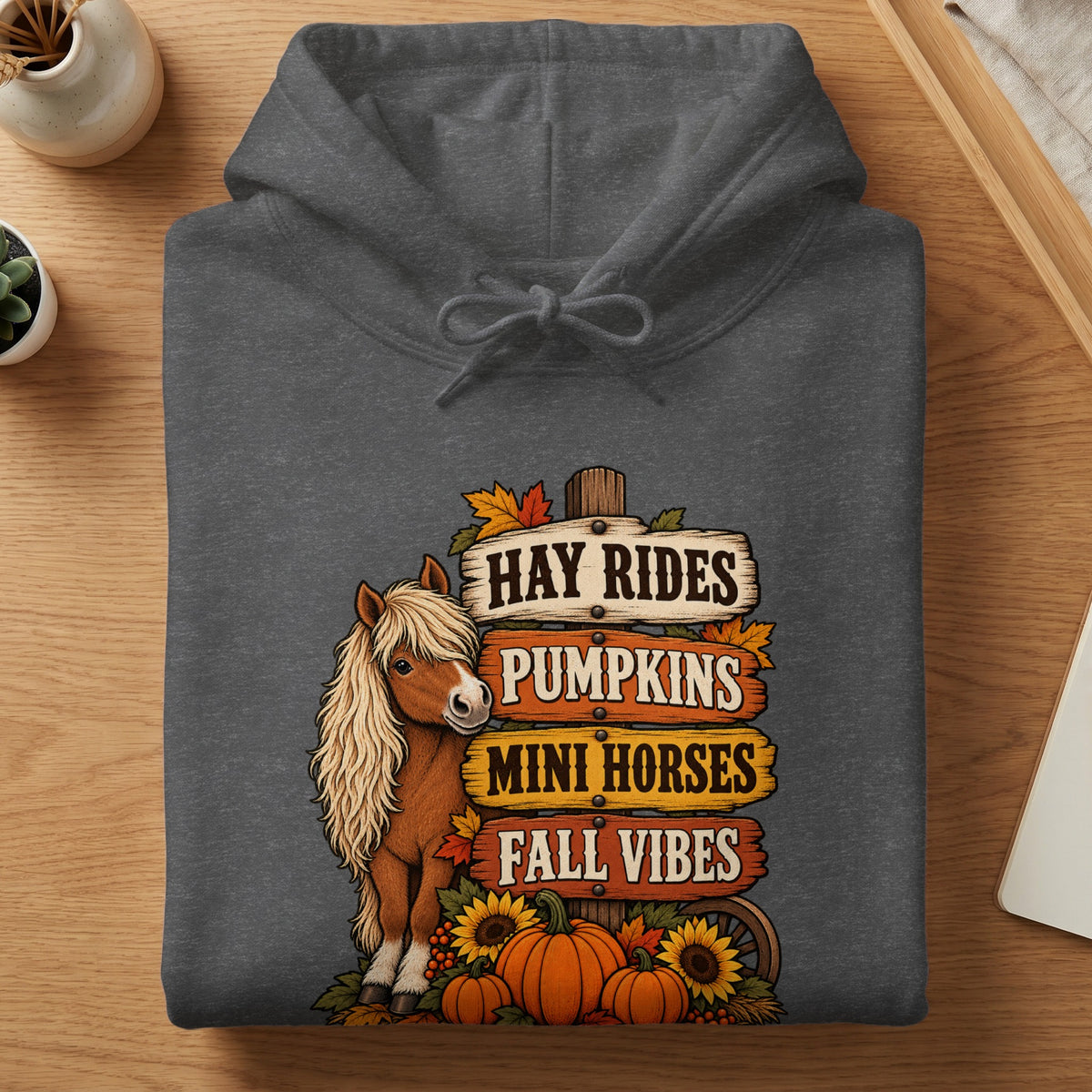 Dark gray hoodie with a graphic of a pony, pumpkins, and fall signs.