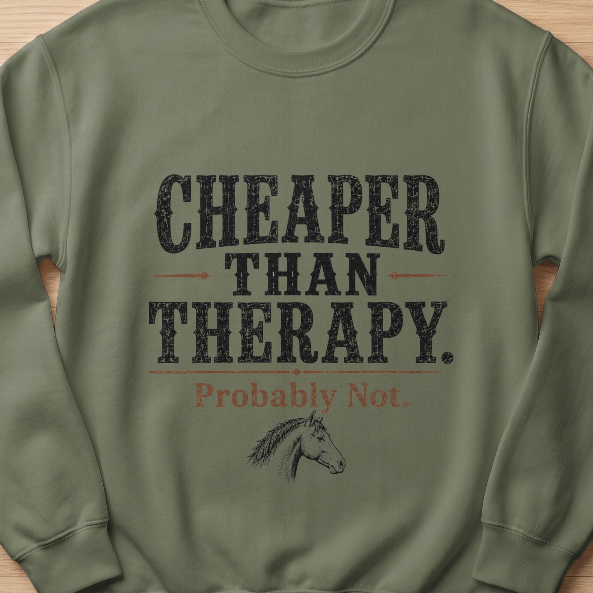 Green sweatshirt with text "CHEAPER THAN THERAPY. Probably Not." and a horse drawing.