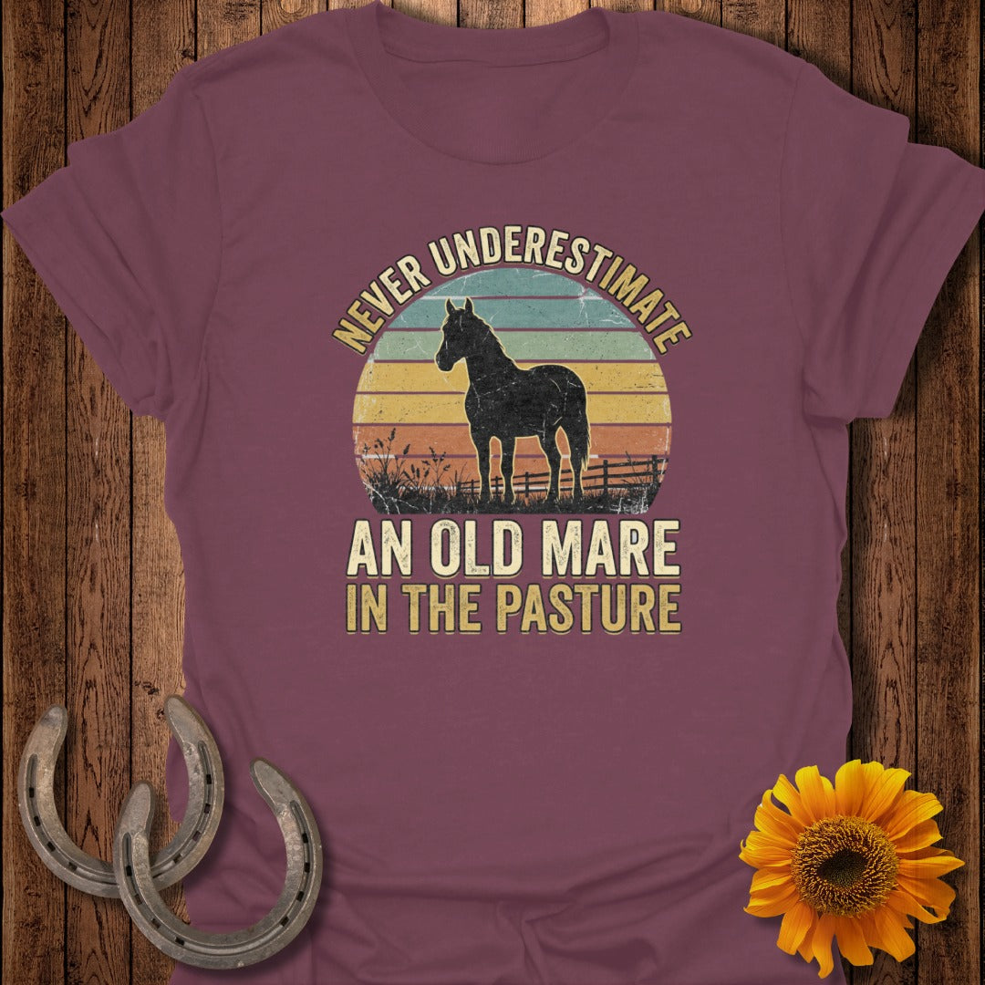 Burgundy t-shirt with vintage sunset graphic and horse silhouette, text "Never Underestimate An Old Mare In The Pasture."