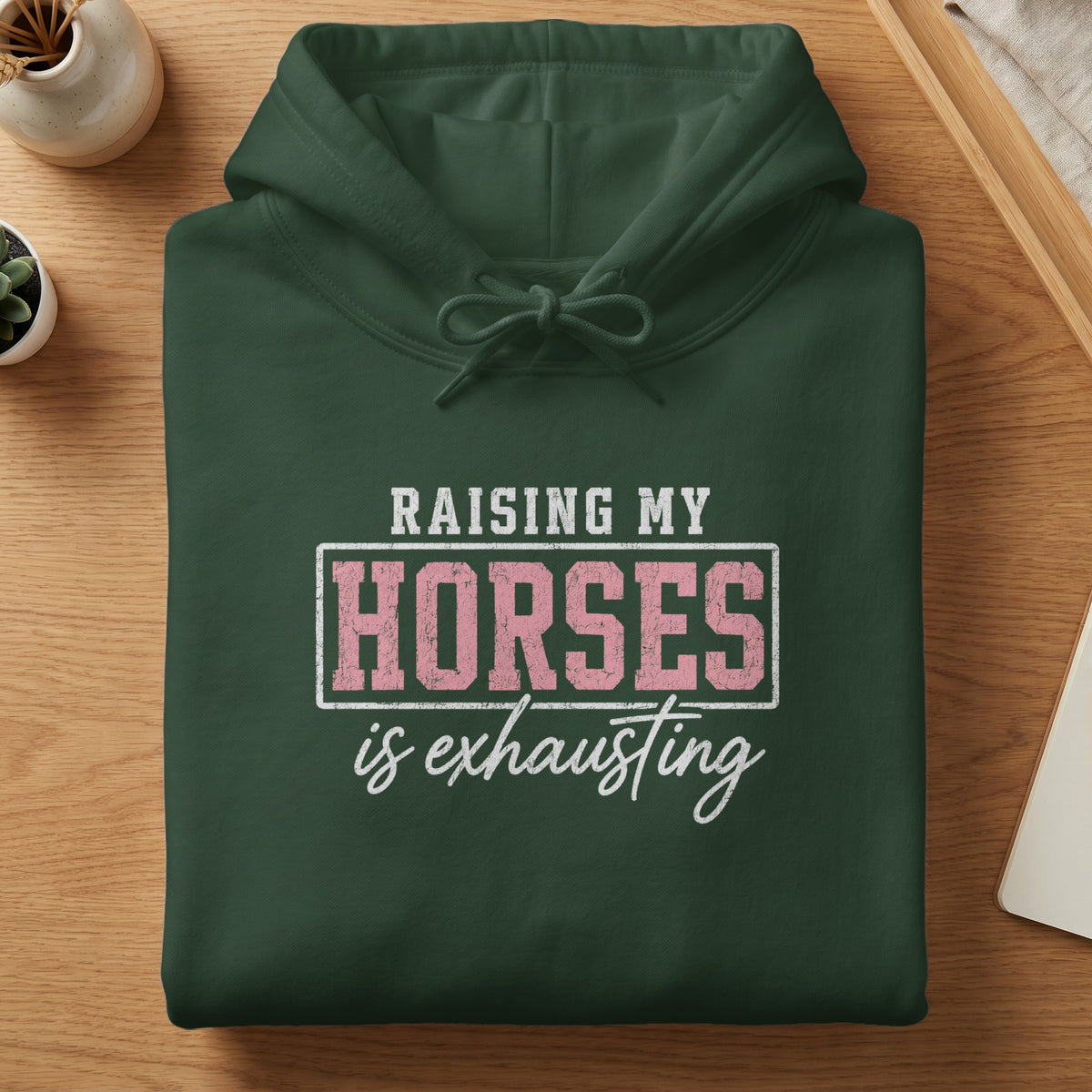 Dark green hoodie with text "RAISING MY HORSES is exhausting"