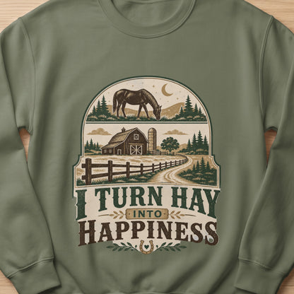 Green sweatshirt with barn, horse, and text "I TURN HAY INTO HAPPINESS".
