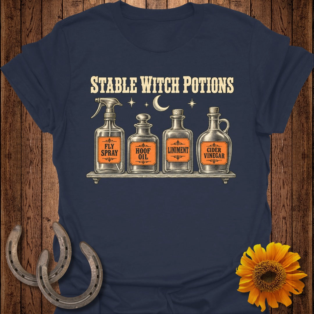 Navy shirt with "Stable Witch Potions" and four vintage potion bottles labeled Fly Spray, Hoof Oil, Liniment, and Cider Vinegar.