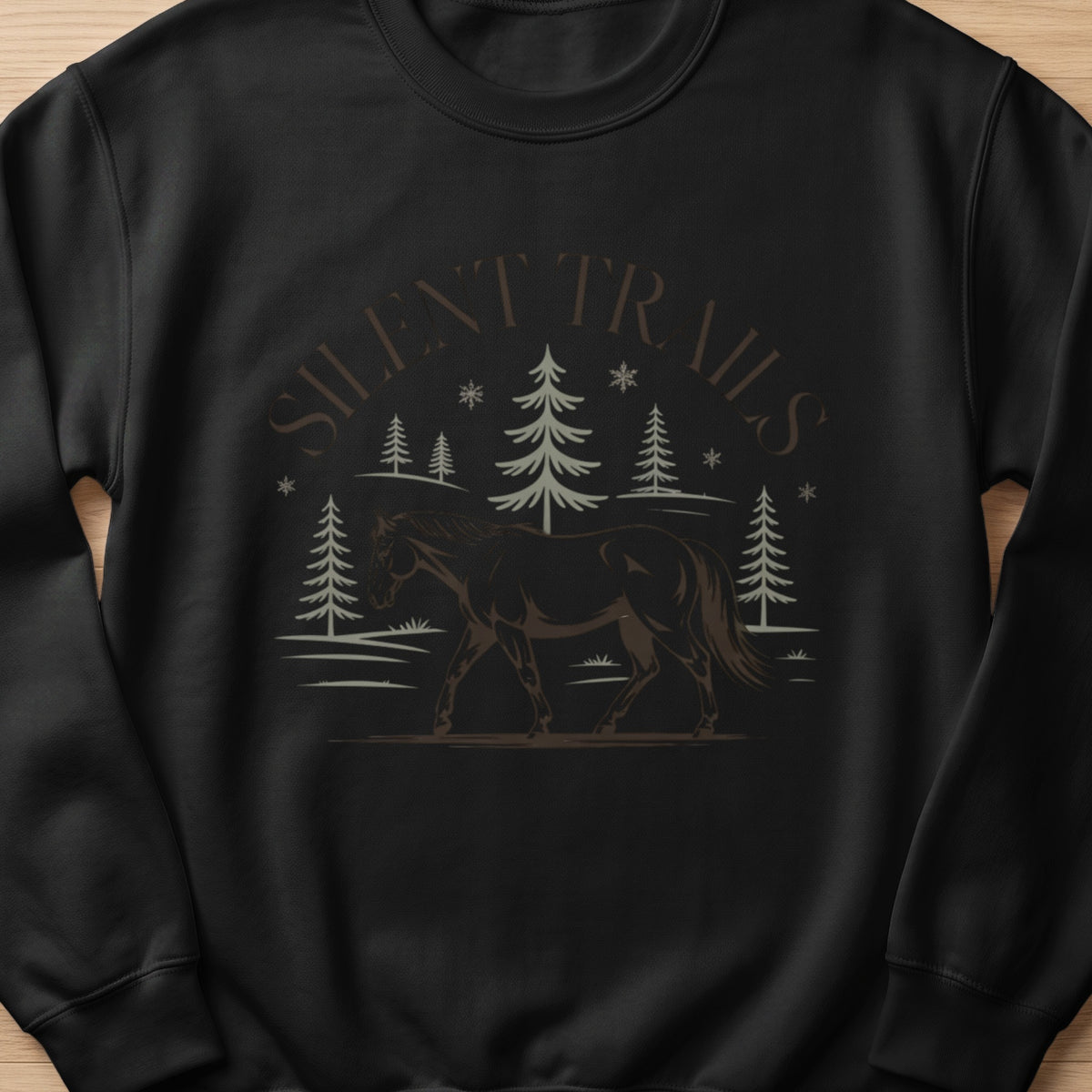Black sweatshirt with a graphic of a horse walking through a forest under the text "SILENT TRAILS".