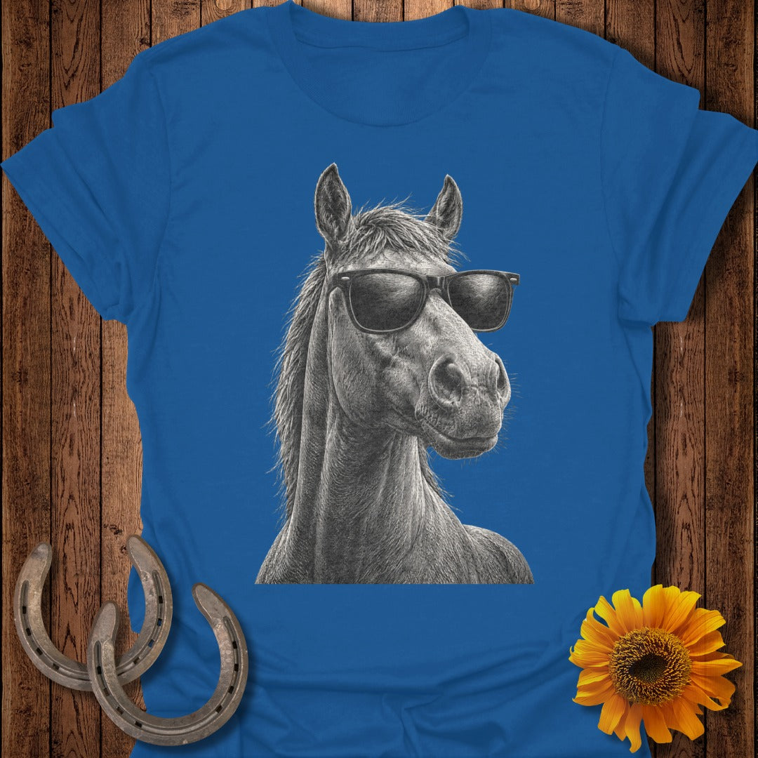 Horse wearing sunglasses, illustrated on a blue t-shirt with sunflowers and horseshoes.
