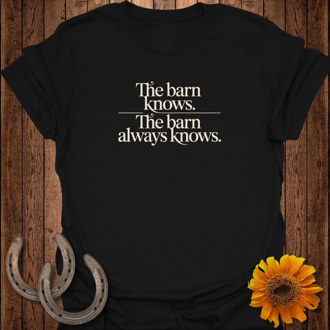 Black t-shirt with white text "The barn knows. The barn always knows."