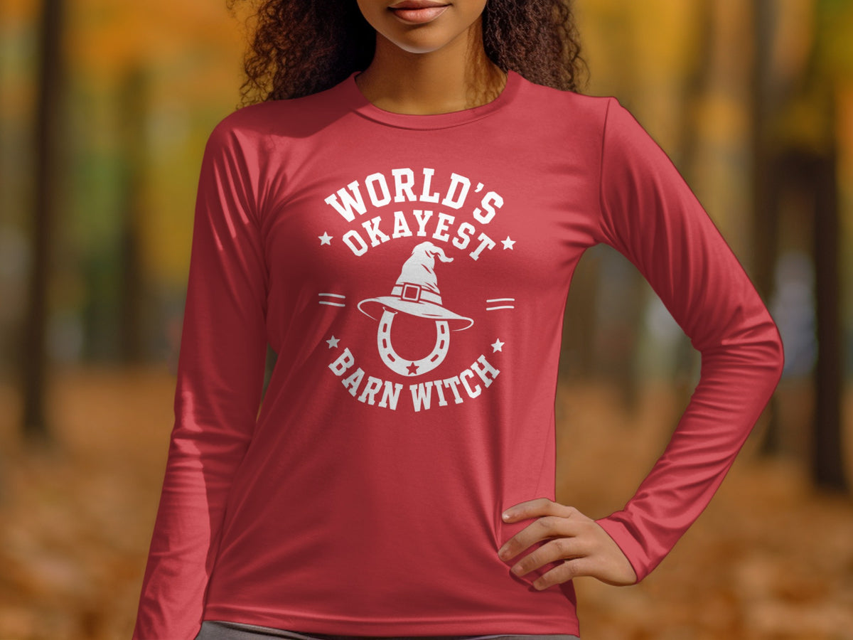 Red long-sleeve shirt with "World's Okayest Barn Witch" graphic and witch hat.