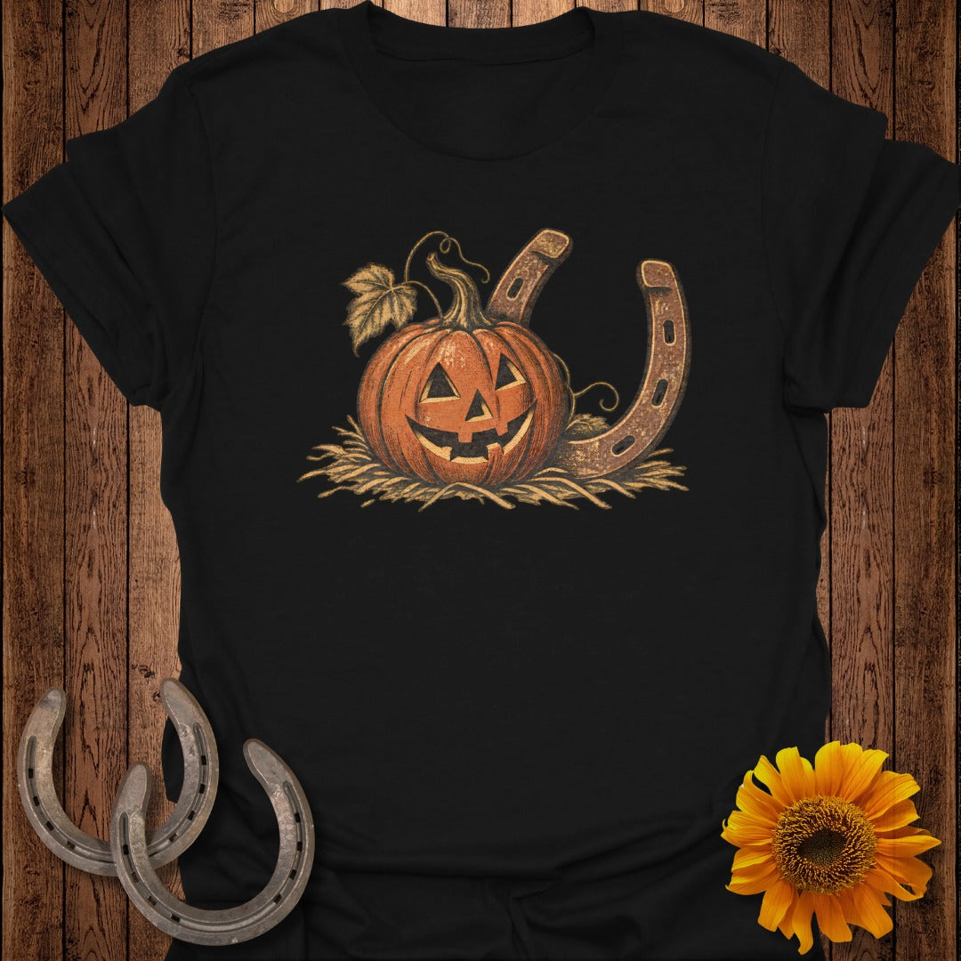 Black t-shirt with a Halloween pumpkin and horseshoe graphic.