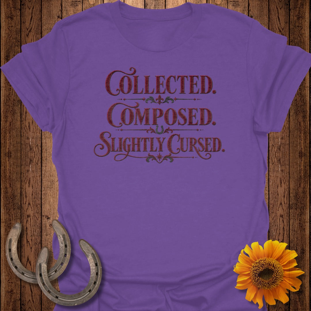 Purple t-shirt with text "Collected. Composed. Slightly Cursed." and decorative elements.