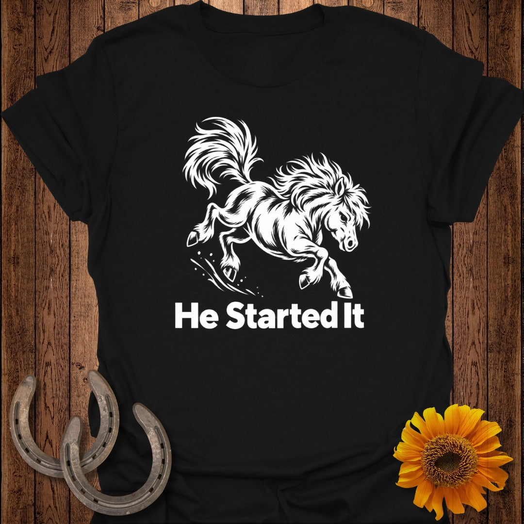 Black t-shirt with white graphic of a galloping horse and text "He Started It".