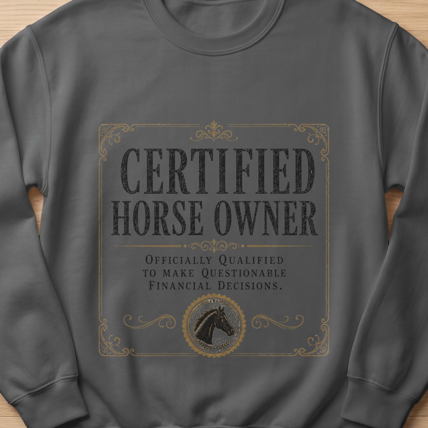 Grey sweatshirt with "Certified Horse Owner Officially Qualified to Make Questionable Financial Decisions." text.