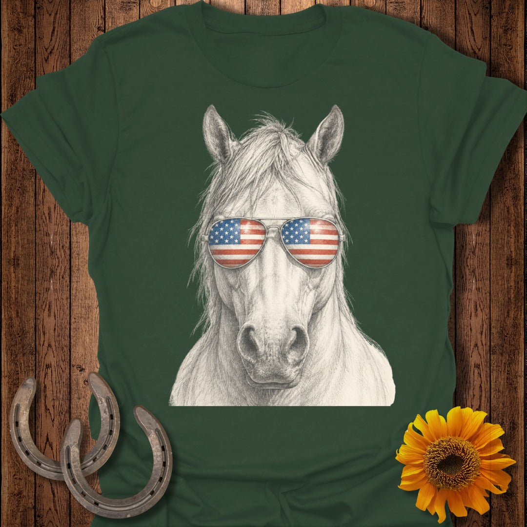 Horse wearing American flag sunglasses, shown on a green t-shirt.