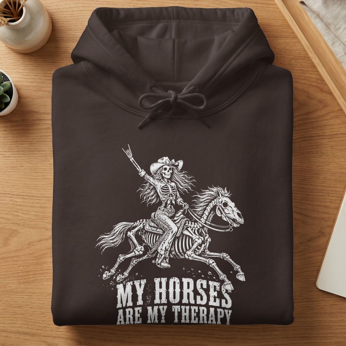 Brown hoodie with skeleton rider and horse graphic and text.