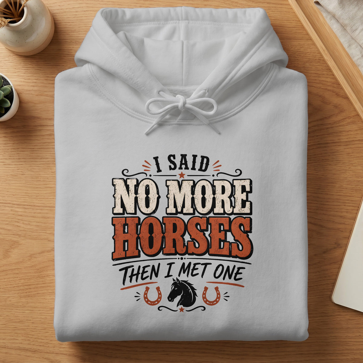 White hoodie with "I SAID NO MORE HORSES THEN I MET ONE" text and horse graphic.