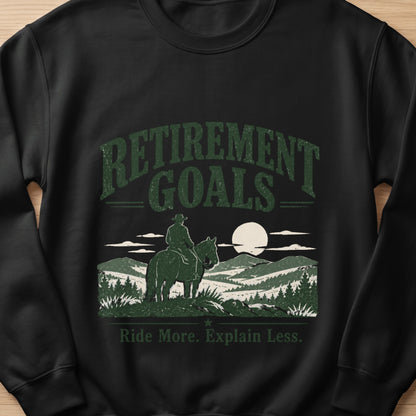 Black sweatshirt with "Retirement Goals" and "Ride More. Explain Less." text and horse graphic.