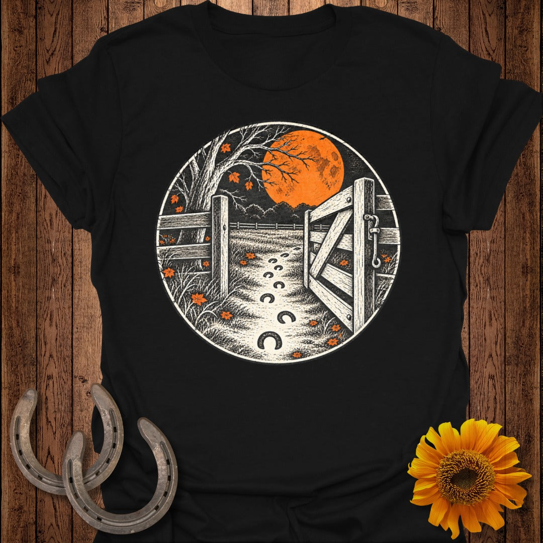 Black t-shirt with circular graphic of an open gate, path with horseshoes, and moon.