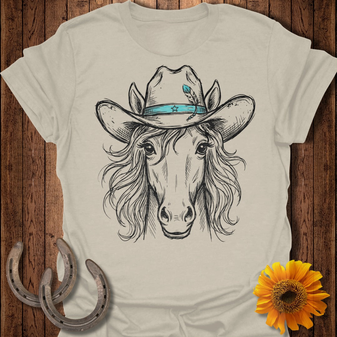 Horse head wearing a cowboy hat with blue feather, tan t-shirt.