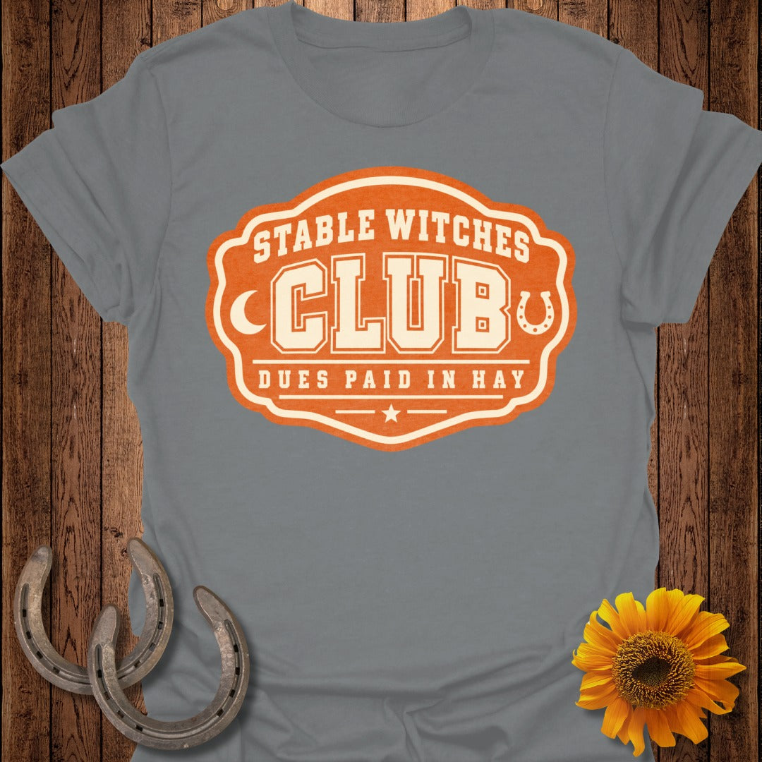 Grey t-shirt with "Stable Witches Club Dues Paid In Hay" graphic.