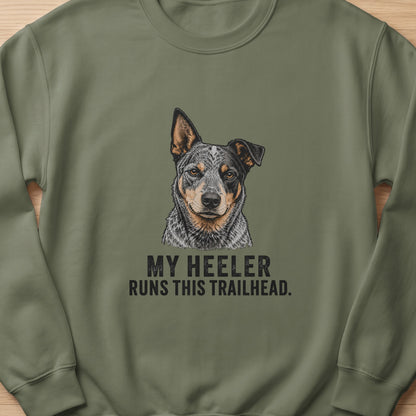 Green sweatshirt with illustration of Australian Cattle Dog and text "MY HEELER RUNS THIS TRAILHEAD."
