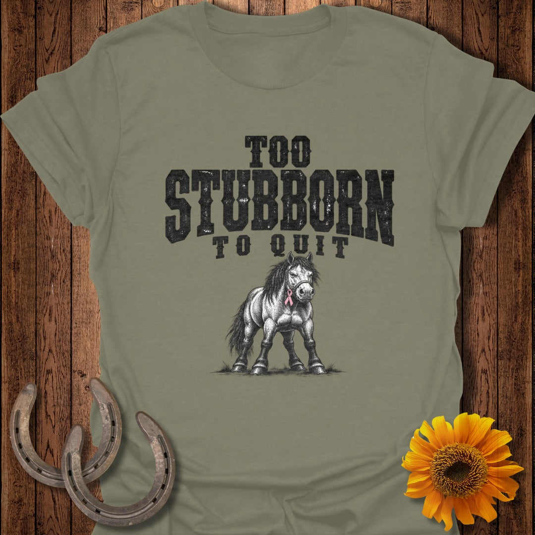 Olive t-shirt with "Too Stubborn To Quit" text and a drawing of a horse wearing a pink ribbon.