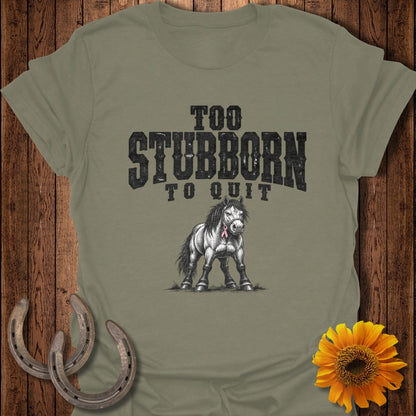 Olive t-shirt with "Too Stubborn To Quit" text and a drawing of a horse wearing a pink ribbon.