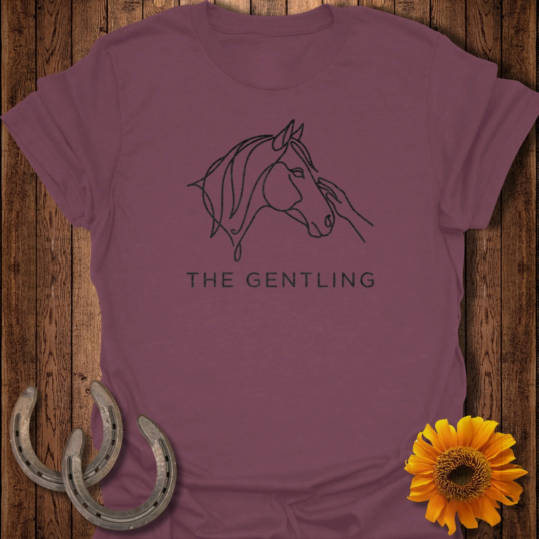 Maroon t-shirt with a line drawing of a horse's head and hand, text "THE GENTLING."