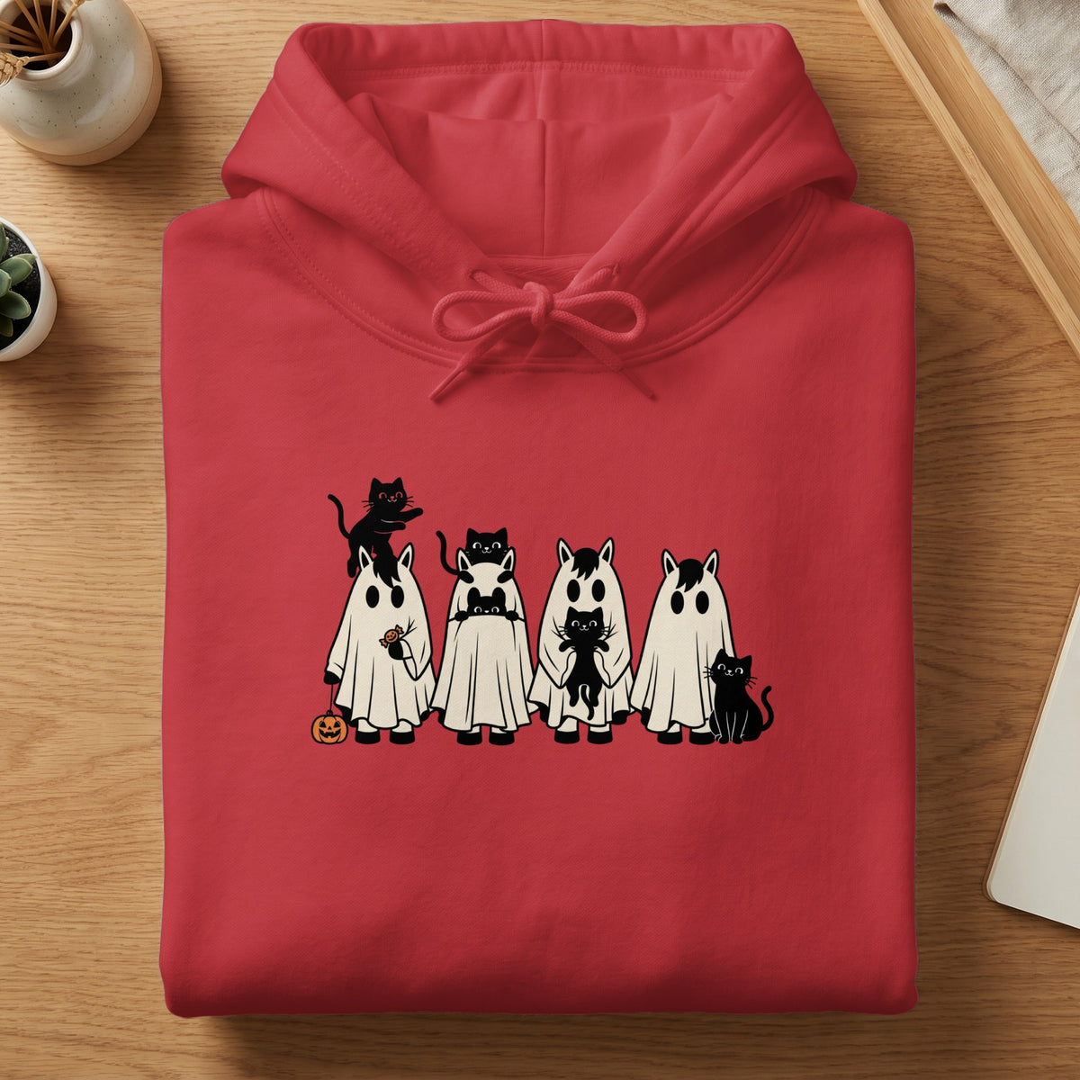 Red hoodie with graphic of horses in ghost costumes and black cats.