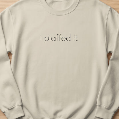 Cream sweatshirt with "i piaffed it" text in black.