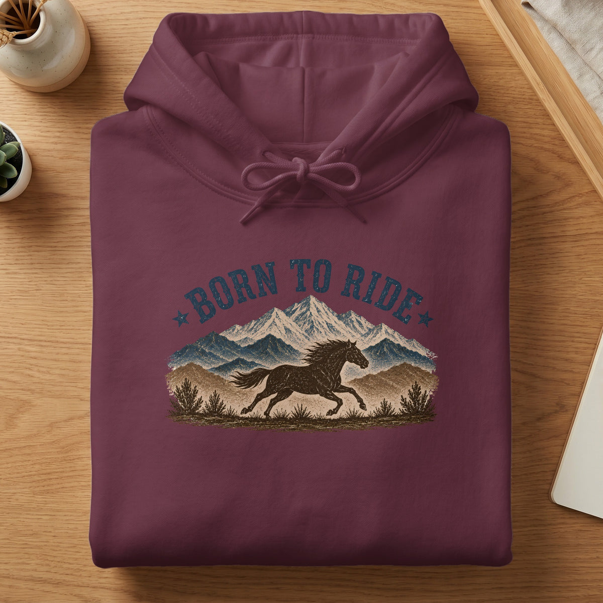 Maroon hoodie with "Born to Ride" text and a running horse with mountains.