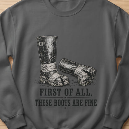Crewneck sweatshirt with a graphic of worn boots and text "FIRST OF ALL, THESE BOOTS ARE FINE".