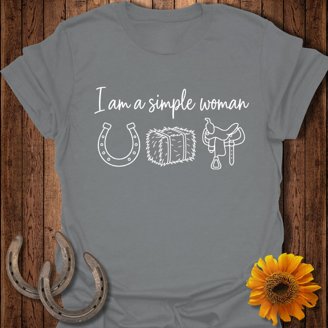 Gray t-shirt featuring the white text I am a simple woman, a horseshoe, hay bale, and saddle.