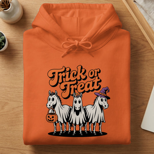 Orange hoodie with a "Trick or Treat" graphic featuring three horses in ghost costumes.