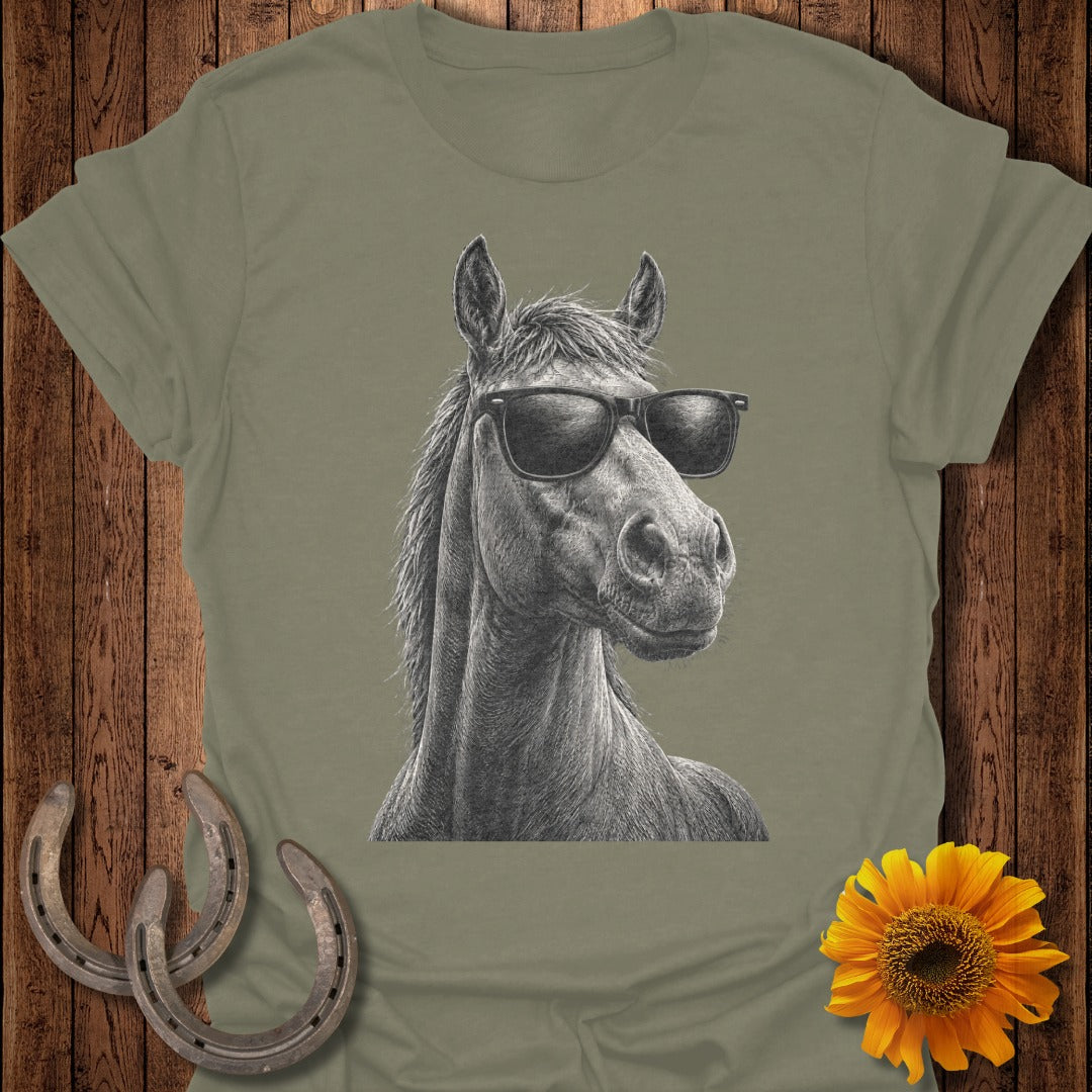 Line drawing of a horse wearing sunglasses on a t-shirt with horseshoes and sunflower.