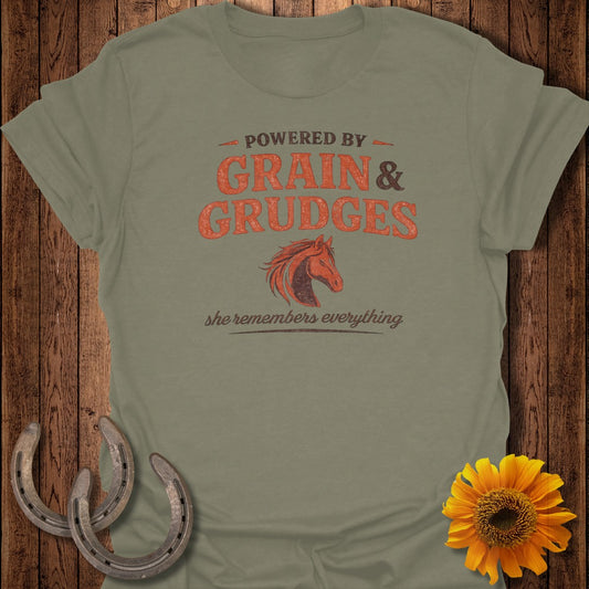 Olive green t-shirt with "Powered by Grain & Grudges" and horse graphic.