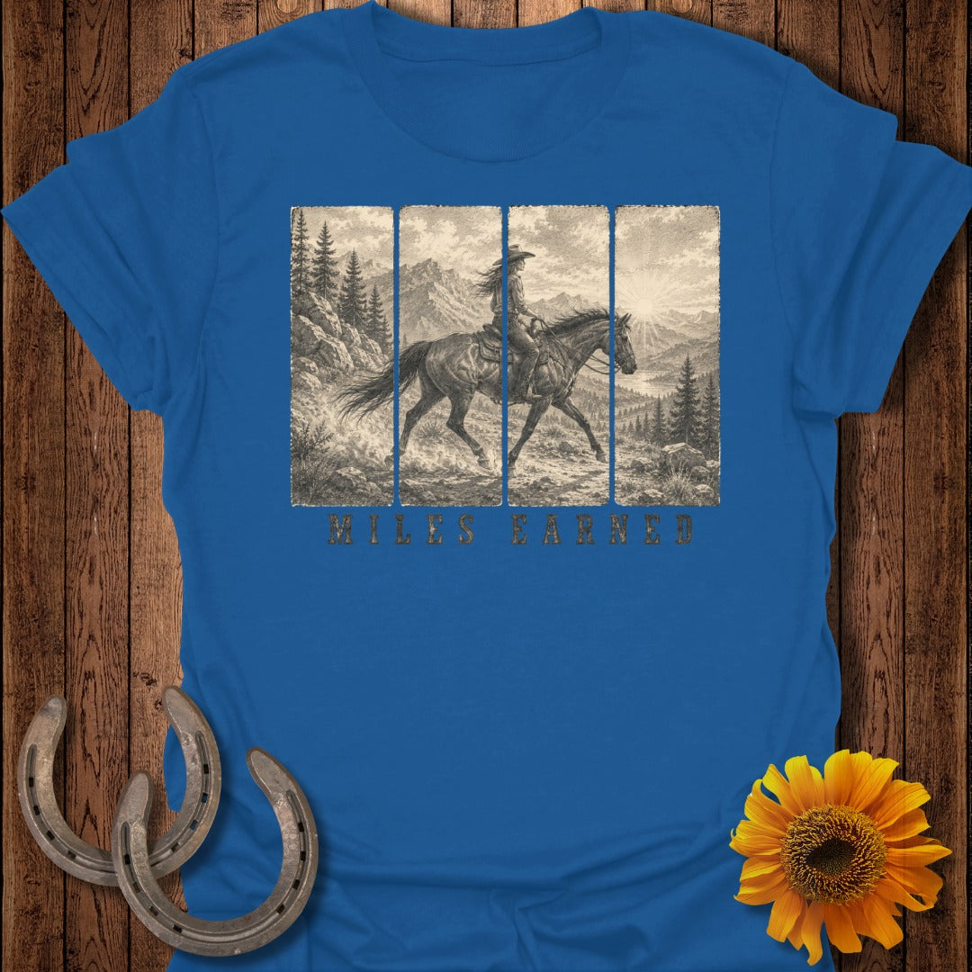 Blue t-shirt with vintage horseback rider graphic and "Miles Earned" text.