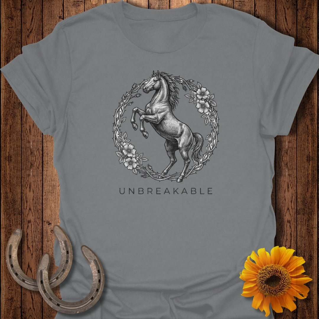 Gray t-shirt with a horse inside a floral wreath and the word "UNBREAKABLE."