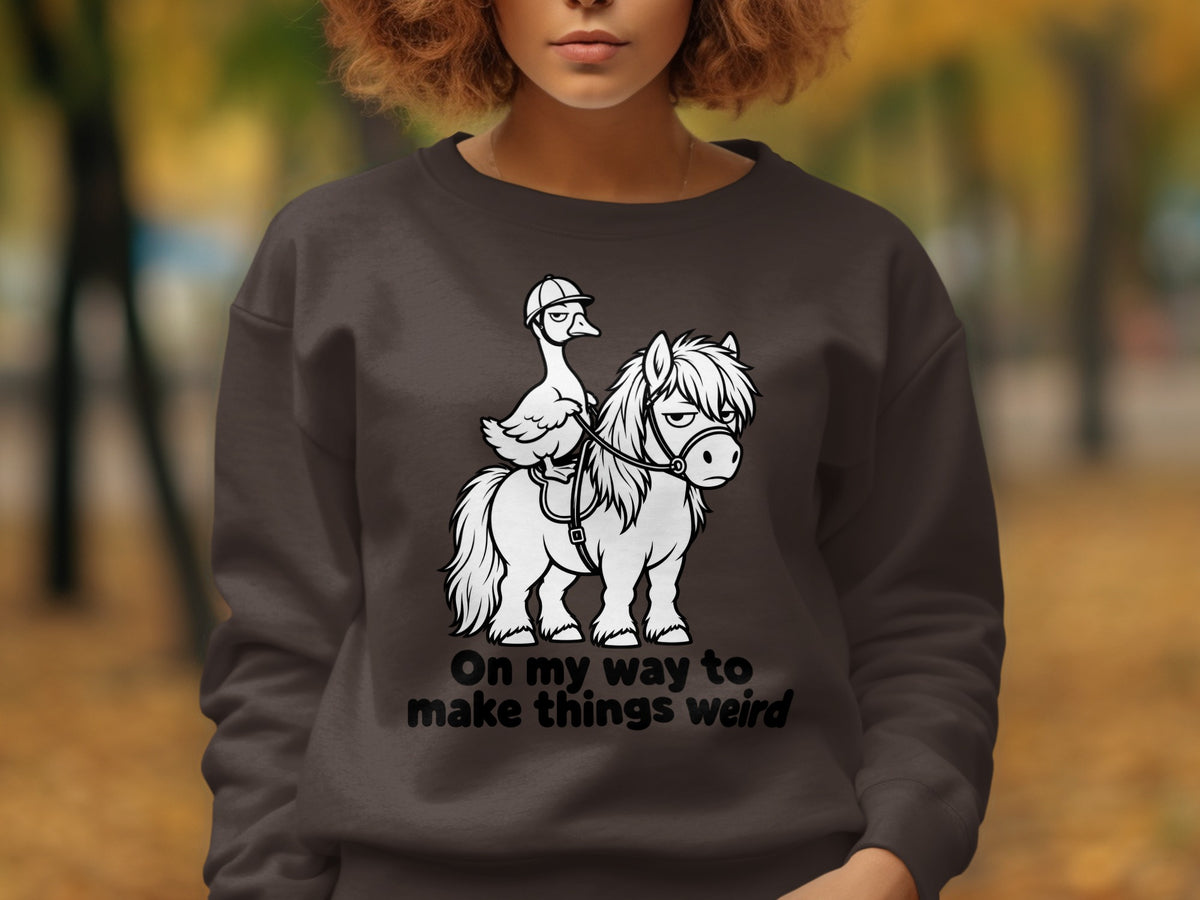 White cartoon duck wearing a helmet rides a horse with text "On my way to make things weird".