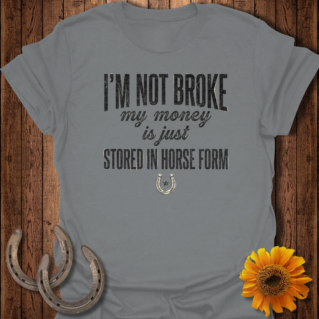 Gray t-shirt with text "I'm not broke my money is just stored in horse form" and horseshoe icon.