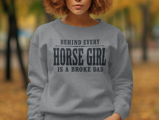 Grey sweatshirt with text "Behind Every Horse Girl Is A Broke Dad"