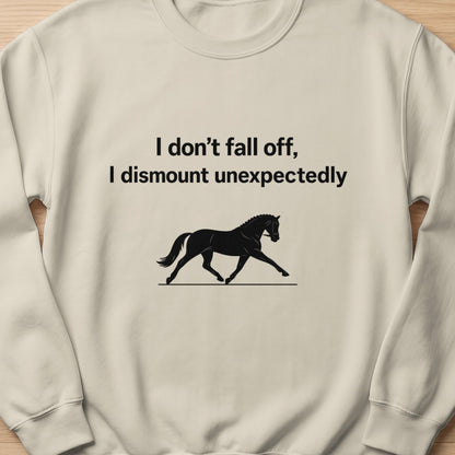 Light cream sweatshirt with black text and horse graphic: "I don't fall off, I dismount unexpectedly."