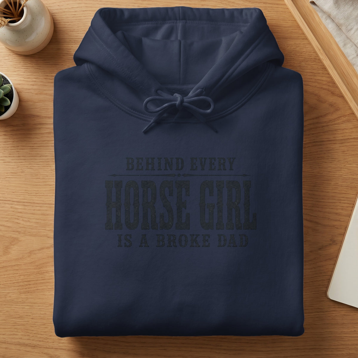 Navy hoodie with "BEHIND EVERY HORSE GIRL IS A BROKE DAD" graphic.