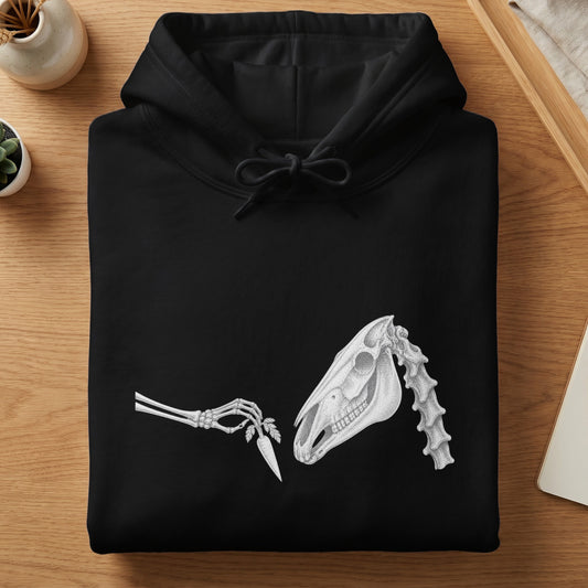 Black hoodie with a white line drawing of a skeleton hand offering a carrot to a horse skull.