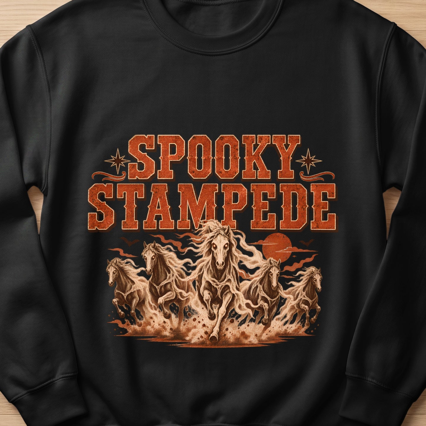 Black sweatshirt with "Spooky Stampede" text and galloping horses design.