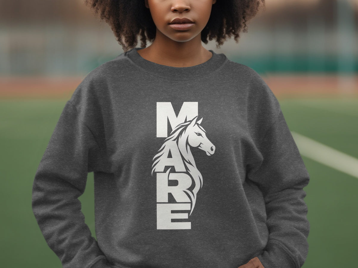 A person wearing a dark grey crewneck sweatshirt with the white text "MARE" featuring an integrated horse illustration.