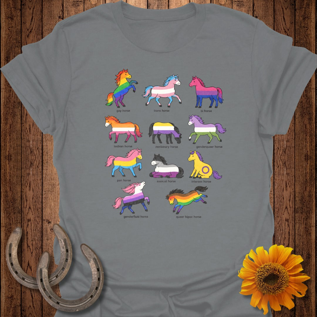 Ten illustrated horses, each with a pride flag mane, are arranged in rows on a grey t-shirt.