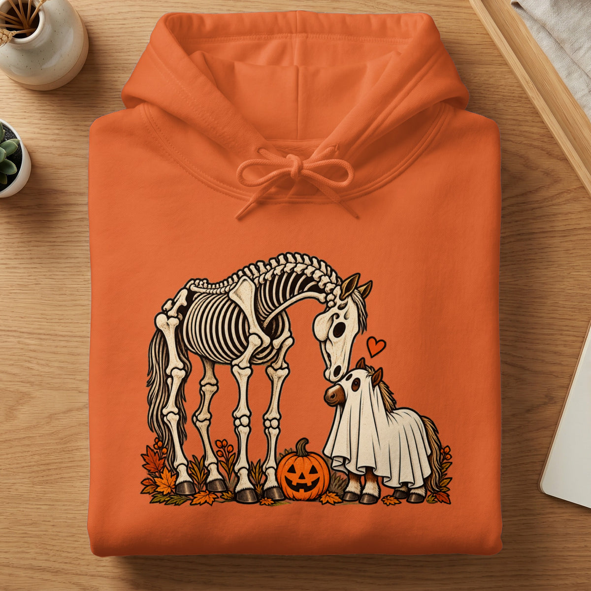 Orange hoodie featuring a skeleton horse and a small horse in a ghost costume.