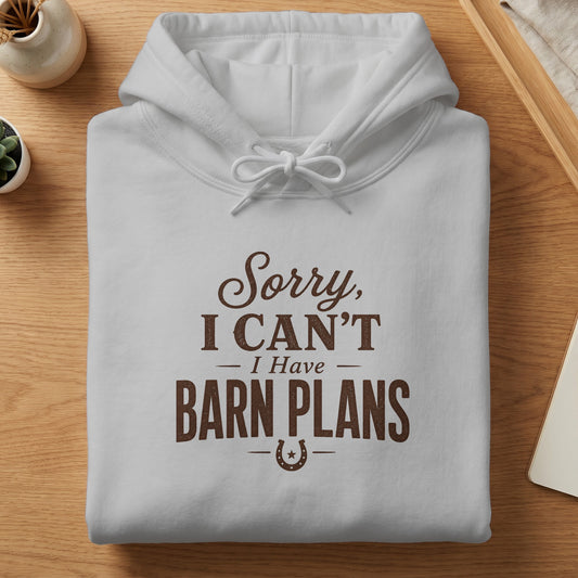 White hoodie with brown text "Sorry, I CAN'T I Have BARN PLANS" and horseshoe graphic.