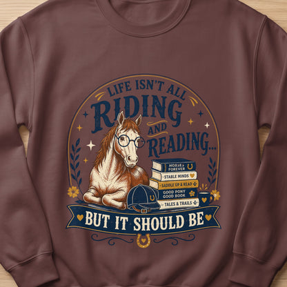 Horse wearing glasses sits by books with text: "Life Isn't All Riding and Reading... But It Should Be."