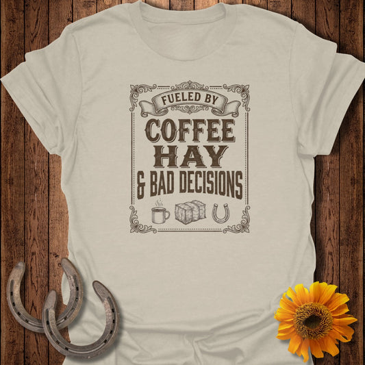 T-shirt with "Fueled by Coffee, Hay & Bad Decisions" text, coffee cup, and horseshoe graphic.
